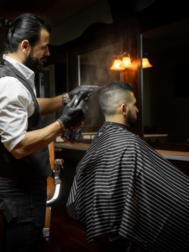 Premium barber working in a warm studio